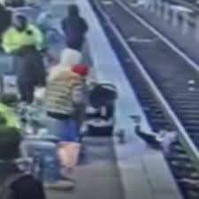Unprovoked' attack: Woman caught on camera pushing 3-year-old girl onto  train tracks