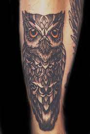 Some common owl tattoos are: Owl Tattoo With Orange Eyes On Leg Shin Shin Tattoo Owl Tattoo Eye Tattoo