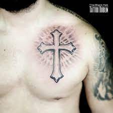 Tribal and cross tattoos on man chest. Pin On The Black Hat Tattoo Dublin