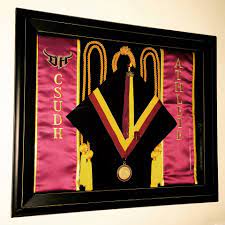 Pin Your Graduation Cap Sash Tassel Cords And Medals To Preserve Them And Display Them Th Shadow Box Graduation Graduation Display Graduation Cap And Gown