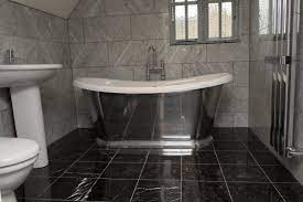 Whether your style is traditional or contemporary, modern or retro, these versatile bathroom tiles are impervious to water and come in an array of colors, styles and textures. Black Marble On The Floor White Marble Bathrooms Black Tile Bathrooms White Marble Tile Bathroom