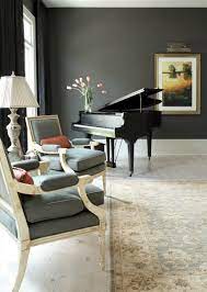 Beautiful living room with baby grand piano beside a round gray and white upholstered ottoman. Decorating A Piano Room Houzz
