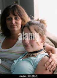 Jennifer Collette, left, with her daughter Amanda, 13, poses at their home,  Thursday, July 21, 2005, in Valparaiso, Ind. Amanda played a "choking game"  where she was choked by another at a neighbor's house last December. Amanda  didn't pass out, but the ...