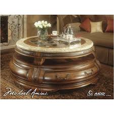 This rustic chic table collection has a tempered glass top with mahogany wood base and unique steel legs with bolt accents. 34204 26 Aico Furniture Tuscano Living Room Round Cocktail Table