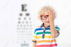 child at eye sight test little kid selecting glasses at optician