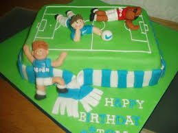 Spread reserved coconut frosting between layers of cake, forming the football. The Blues Football Cake