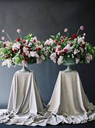 Their wardrobe balances the natural surroundings with a floral wedding dress. Moody Black Wedding Inspiration Two Large Flower Urns With Red And Light Pink Flowers Crimson Letters