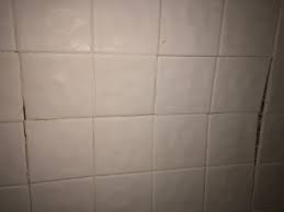 Do you have tile that needs toe removed?*= just use a mastic glue. A Guest Pushed In My Shower Wall Tile How Can I Fix It Home Improvement Stack Exchange