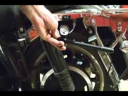 Motorcycle Repair Adjusting The Rear Suspension Air System Shocks On A Harley Davidson