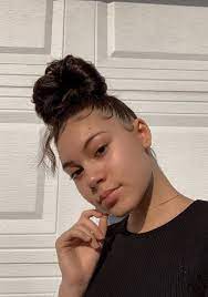 This kid hairstyle is the right styling choice for girls with dry and tender hair. Top Knot Bun With Baby Hair Natural Hair Styles Messy Hair Look Braided Bun Hairstyles