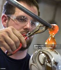 Art of Fire artist Josh Ries works with molten glass as he creates a...  News Photo