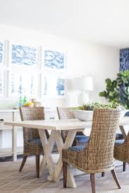 Solids, stripes, tapestries, botanicals and a host of other patterns will make each wicker dining room furniture ensemble your own. Placed On A Brown Diamond Print Rug A Light Wood Dining Table Is Flanked By Six Wicker Chairs Cottage Dining Rooms Wood Dining Room Table Woven Dining Chairs