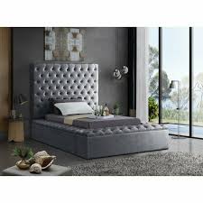 Modern velvet upholstered bed with squared detailing and tufting on headboard and plastic legs with wood look finish. Geralyn Tufted Upholstered Storage Platform Bed