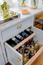 Pull Out Liquor Drawers Concealed In A Light Gray Shaker Cabinet With Brass Cup Pulls Under A White An Kitchen Remodel Small Kitchen Renovation Kitchen Remodel