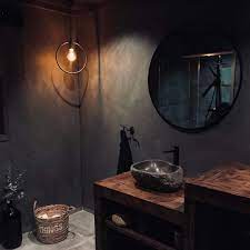 The white bathtub in the middle of this bathroom will make the room attractive and provide the perfect contrast. 25 Photo Ideas To Embrace Dark And Moody Colours For Your Bathroom
