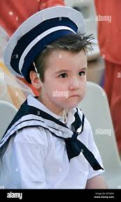 Little sailor.Boy with snot in his nose dressed in navy costume Stock Photo 