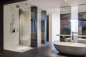 Although the bathroom is completely new, antique brass fixtures and a distressed mirror frame make this space feel as though it's been there forever. Contemporary Ensuite Bathroom With Cutting Edge Design In Sydney