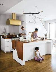 The gold barstools tie into the other gold accents seen throughout this kitchen space in the range hood and pendant lights. Ways To Use Gold Accents In The Kitchen Collection Of 6 Photos By Erika Heet Dwell
