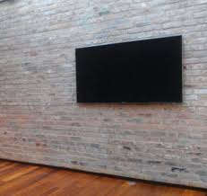 Tv connect & setup from geek squad® Tv Mounted On Brick Wall With No Visible Cables Brick Wall Tv Tv Mounted Wall Mounted Tv