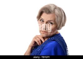 Isolated portrait of a single female Blue rock thrush bird eating an insect  in the wild- Armennia Stock Photo