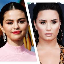 By debuting a freshly chopped 'do. Demi Lovato Talks Selena Gomez Friendship In Harper S Bazaar