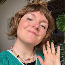 Hi 👋 Here's my face! My name is Meg, and I love working in glass. I  started in flame working (I made some of the beads in my necklace!) but it  wasn't