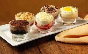Vanilla ice cream with chocolate syrup, whipped cream and a cherry. Dolcini Lunch Dinner Menu Olive Garden Italian Restaurant Desserts Olive Garden Desserts Dessert Shooters