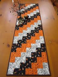 Learn how to make table runner patterns for the holidays and more with these 30 gorgeous table runner tutorials and patterns. Crafts Table Creative Halloween Table Runner With Candy Corn Stars And Spiders Halloween Table Runners Quilted Table Runners Christmas Quilted Table Runners Patterns
