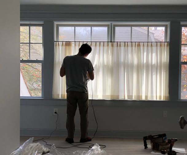 Abbey Wood curtain track being installed along bay window
