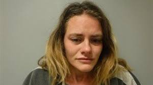 Woman arrested after she's found asleep in car, loaded gun beside her