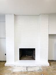 When the first coat of paint dries, apply a color wash and then quickly wipe it off with a clean, dry towel. One Room Challenge Week 3 Old Brick Fireplace Makeover The Happy Housie