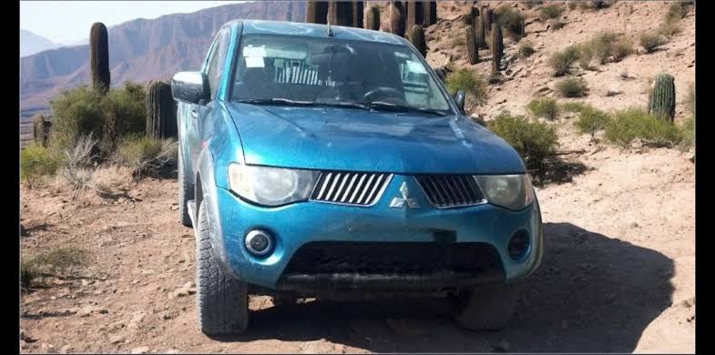 A well-maintained 2007 Mitsubishi L200 pickup in factory metallic blue color., AI generated