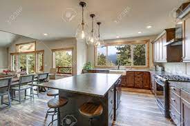 From the living room's point of view, the kitchen is hidden behind the narrow separation that you can only spot the island bar. Luxurious Open Plan Kitchen Design With Large Center Island And Stock Photo Picture And Royalty Free Image Image 114014832