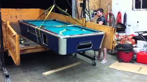 Because of its size and heavy weight, you should always disassemble a furniture style pool table before with a staple remover or a flat head screwdriver, lie on your back under the table and remove all the staples that hold the pockets in place. Best Pool Table Moving Tips Snookerly