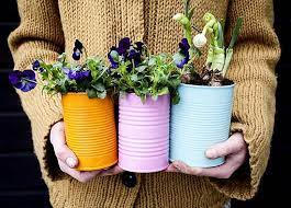 If you're a gardener, then chances are you're probably already pretty crafty. Bring A Gift Of Spring Dosfamily Painted Tin Cans Diy Planters Flower Pots