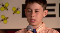 Pan Across Girls Sitting On Stage To Nervous Boy Spelling Word In Spelling Bee  Pan Back To Girl Grimacing Los Angeles