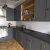 Pale grey light grey kitchen cabinets with dark countertops. 3
