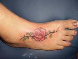 Blue small traditional flower tattoo on foot. 39 Awesome Rose Foot Tattoos
