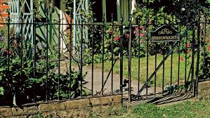 This metal gate is a. How To Paint Metal Railings Cleaning And Repairing Railings And Gates Real Homes