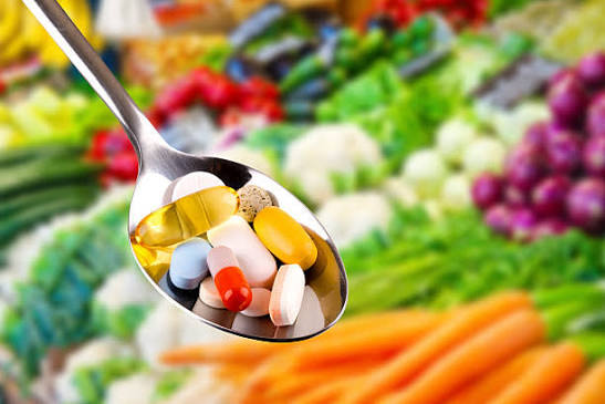 Nutritional supplements and vitamins arranged on a clean surface