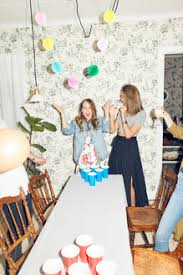 Part of preparing for any party is planning a way to keep guests entertained. Surprised Young Woman Playing Beer Pong With Friends During Dinner Party At Home Stockphoto