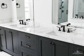 Black And White Master Bathroom Designed With Matte Black Faucets Over A White And Gray Marb White Master Bathroom Black And White Master Bathroom Black Faucet