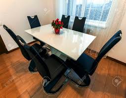 Modern dual tone extendable dining table: White Wooden And Glass Round Dining Table With Six Chairs Modern Design Dining Table And Chairs In Contemporary Kitchen Series Of Furniture Stock Photo Picture And Royalty Free Image Image 114002324