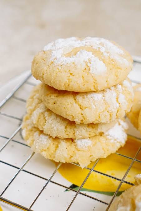 Very Lemon Crinkle Cookies stacked with snowy crackled tops