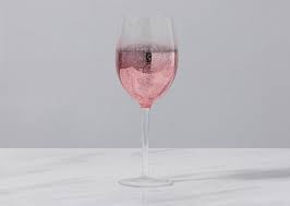 All purpose wine glass is trimmed in a delicate gilded rim, and its elegant lines bring sophistication and glamour to every table. Shimmer Wine Glass Rose Gold Urban Barn