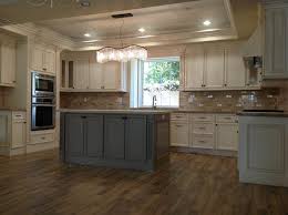 White and gray kitchen features a light gray glass backsplash complementing white flat front cabinets topped with a gray quartz countertop. Antique White Cabinets With Gray Island My Ideal Home