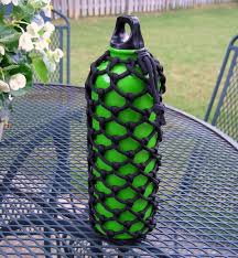 Attaching the carabiner to the bottle holder. 60 Easy Paracord Project Tutorials Ideas Hative