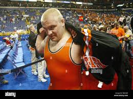 Heavyweight wrestler Steve Mocco of Oklahoma State puts on a warmup top as  he leaves the ring after defeating Minnesotas Cole Konrad in the 2005 NCAA  Division 1 Wrestling Championships at the