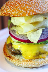 Or 2 dashes tabasco sauce · 1/4 teaspoon dried thyme leaves · salt and freshly ground black pepper, to taste · vegetable oil, for grilling · 4 slices cheddar cheese · 4 hamburger buns, toasted, for serving · thinly sliced ripe tomato. Chef Bobby Flay Brings Bobby S Burger Palace Chain To The Las Vegas Strip Vital Vegas