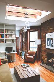 The Best Way To Make A Small Space Work Is To Find The Hidden Gems The High Ceilings Exposed Brick And Ridiculous Skylight In Home Home Decor House Interior